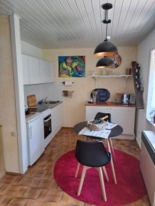 a kitchen with a table and chairs in a room at Wasgauer Felsen und Seen in Ludwigswinkel
