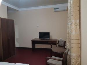 a room with a desk with a computer and a chair at Гостевой дом Barakat in Samarkand