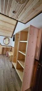 a room with wooden shelves in a tiny house at Cabana dintre Salcami in Durau