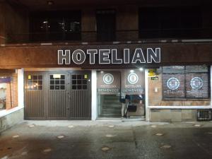 a hotel sign on the front of a building at Hotel Iam Armenia Quindio in Armenia