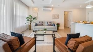 a living room with a couch and a table at Coral Beach 202 condo in Saint Peter
