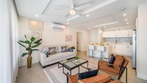a living room with a couch and a table at Coral Beach 202 condo in Saint Peter