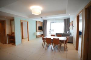 a living room with a table and chairs and a couch at Zephyr Agadir in Agadir