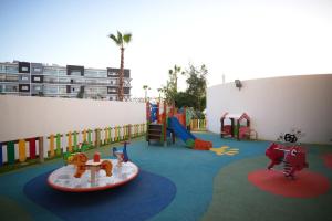 a childrens playground with a slide and a play area at Zephyr Agadir in Agadir