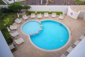 an overhead view of a large swimming pool with lounge chairs and sidx sidx at Zephyr Agadir in Agadir