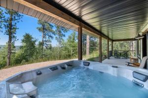 una vasca idromassaggio sul retro di una casa di Rustic Peaks Cabin with Hot tub a Lead