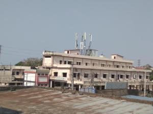 a building with an antenna on top of it at Aditya Lodge in Warangal