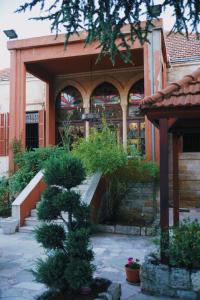 a building with a staircase in front of a garden at Beit Melhem in Zahlé