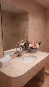 a bathroom counter with a sink and a mirror at El Ático in Alicante