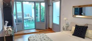 a bedroom with a bed and a sliding glass door at Villa Angelus in Nice
