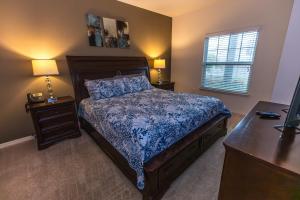 a bedroom with a bed and two night stands and a window at Elegant, Spacious 3bedroom Near Attractions Hot Tub Pool & Gym in Kissimmee