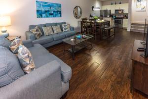 a living room with a couch and a table at Elegant, Spacious 3bedroom Near Attractions Hot Tub Pool & Gym in Kissimmee