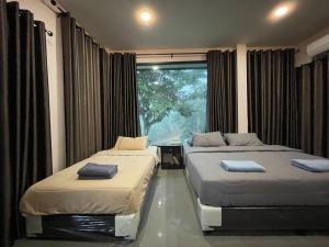 Ένα ή περισσότερα κρεβάτια σε δωμάτιο στο บ้านสวนปันสุข วังน้ำเขียว