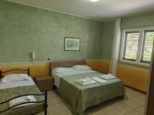 Postel nebo postele na pokoji v ubytování Hotel Roma Sul Mare
