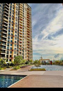 a large apartment building with a pool in front of it at Luxury 2 bedroom 2 bath Apartment near Bai Hotel in Mandaue City