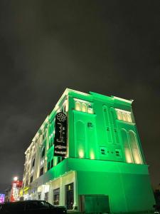 a green building with a sign on top of it at ليبرا سويتس - Libra Suites in Khamis Mushayt