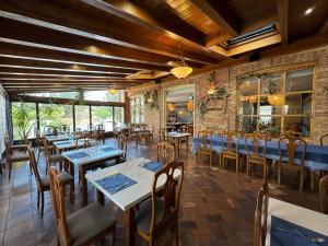 a restaurant with tables and chairs in a room at Albergue Jakue in Puente la Reina
