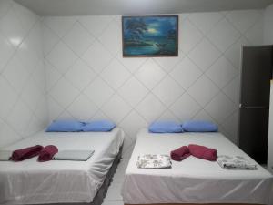 Postel nebo postele na pokoji v ubytování Suítes Centro Praia