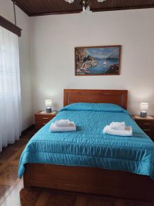 a bedroom with a bed with two towels on it at Vista de Sonho in Calheta +6 photos