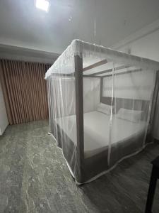 a bed with a canopy in a room at Eleven Thalalla in Talalla South