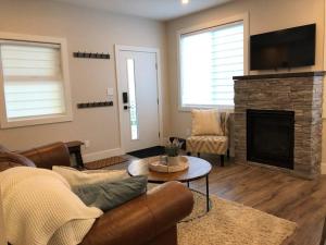 a living room with a couch and a fireplace at Executive 1 Bedroom Lakeview Retreat in Shawnigan Lake