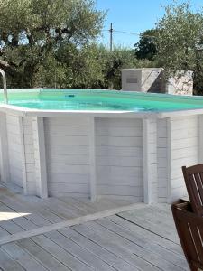 a hot tub on a deck with a pool at Trullo Sofia in Monopoli