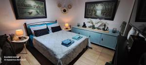 a bedroom with a bed with blue sheets and blue pillows at Zoe garden home in Spata