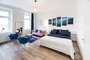 a bedroom with a bed and a living room at Radiant Premium Apartments - Fünfhaus in Vienna