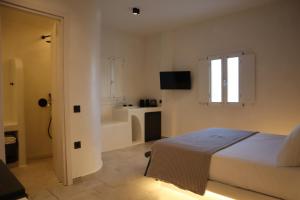 Postel nebo postele na pokoji v ubytování Santozen Suites