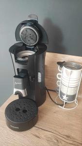 a coffee maker sitting on top of a wooden table at Studio mer in La Plaine-sur-Mer