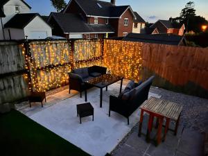 a backyard with a fence with lights on it at Devon Bungalow in Holsworthy