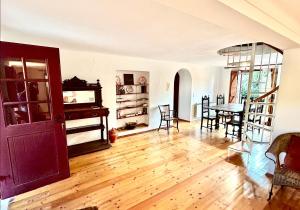 a living room with a wooden floor and a table at Casa do Reguengo (New!) in Castelo de Vide