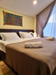 two beds in a hotel room with towels on the bed at Lea Guest House in Tbilisi City