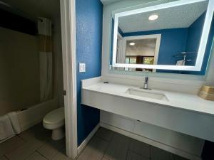 a bathroom with a sink and a mirror and a toilet at Knights Inn Greenville in Greenville