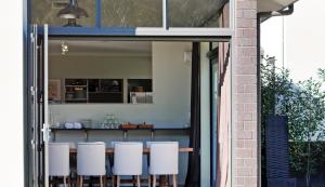 a room with a table and some white chairs at Kaitahi Lodge in Palmerston North
