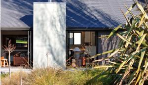 a modern house with a blue roof at Kaitahi Lodge in Palmerston North