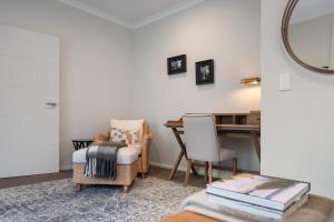 a living room with a table and two chairs at Kaitahi Lodge in Palmerston North