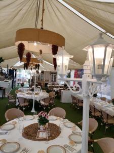 a tent with white tables and chairs and lights at Villas de Miranda in Miranda de Azán