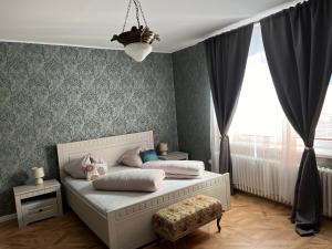 A bed or beds in a room at Apartments Zámoček Staré časy