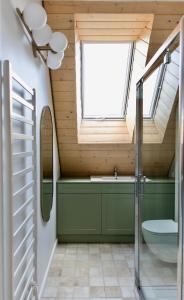 a bathroom with a toilet and a sink and a window at Biestroska - apartamenty widokowe in Wetlina
