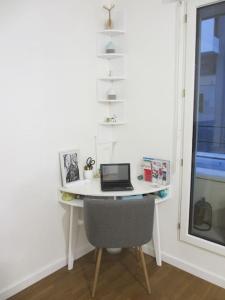 a desk with a laptop computer on it in a room at RER C Les Grésillons NEAR PARIS in Asnières-sur-Seine +18 photos