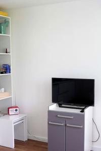 a flat screen tv sitting on top of a entertainment center at RER C Les Grésillons NEAR PARIS in Asnières-sur-Seine