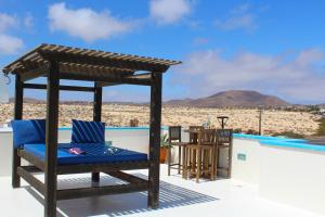 a chair on a roof with a view of the desert at Villa Eesha by Privilege Bay in La Oliva
