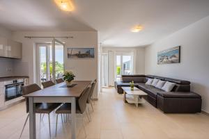 a living room with a couch and a table at Villa Tonka in Nova Vas