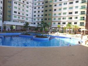 a large swimming pool in front of a building at Riviera Park in Caldas Novas