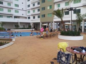 a pool at a hotel with people swimming in it at Riviera Park in Caldas Novas