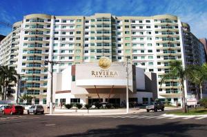 a large white building with a sign for a hotel at Riviera Park in Caldas Novas