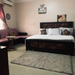 a bedroom with a large bed and a couch at HP Pavilion in Abuja +62 photos
