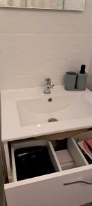 a bathroom sink with two cups on top of it at Hôtel Restaurant Les Alizes Loriol Le Pouzin in Le Pouzin +25 photos