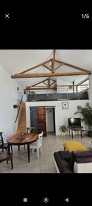 a living room with a table and a couch at La Bergerie in Narbonne
